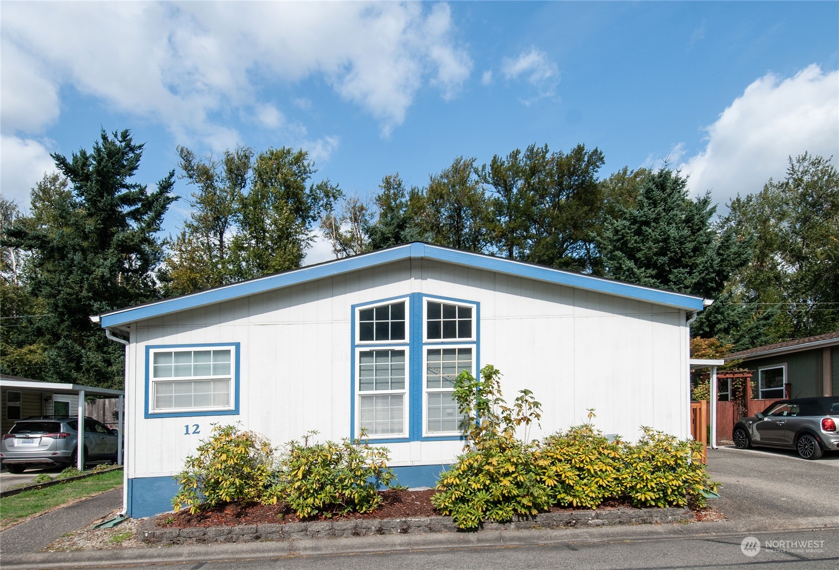 15400 Southeast 155th Place, Unit 12 Renton, WA 98058 - Photo 1 of 21 a front view of a house with a yard