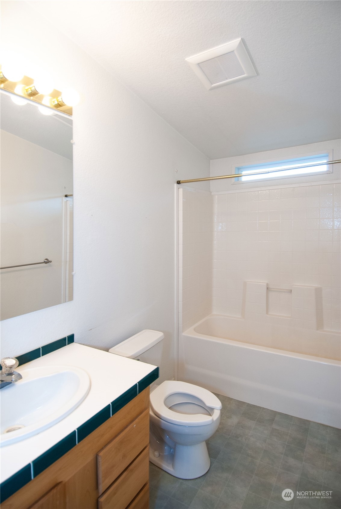 15400 Southeast 155th Place, Unit 12 Renton, WA 98058 - Photo 16 of 21 a bathroom with a sink a toilet and shower