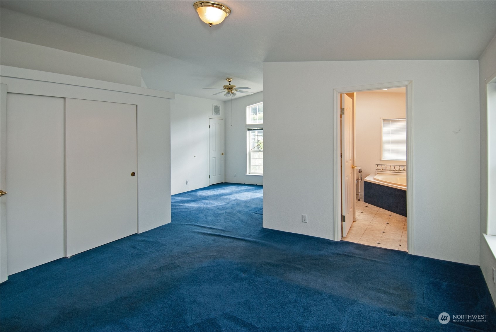 15400 Southeast 155th Place, Unit 12 Renton, WA 98058 - Photo 18 of 21 an empty room with wooden floor and windows