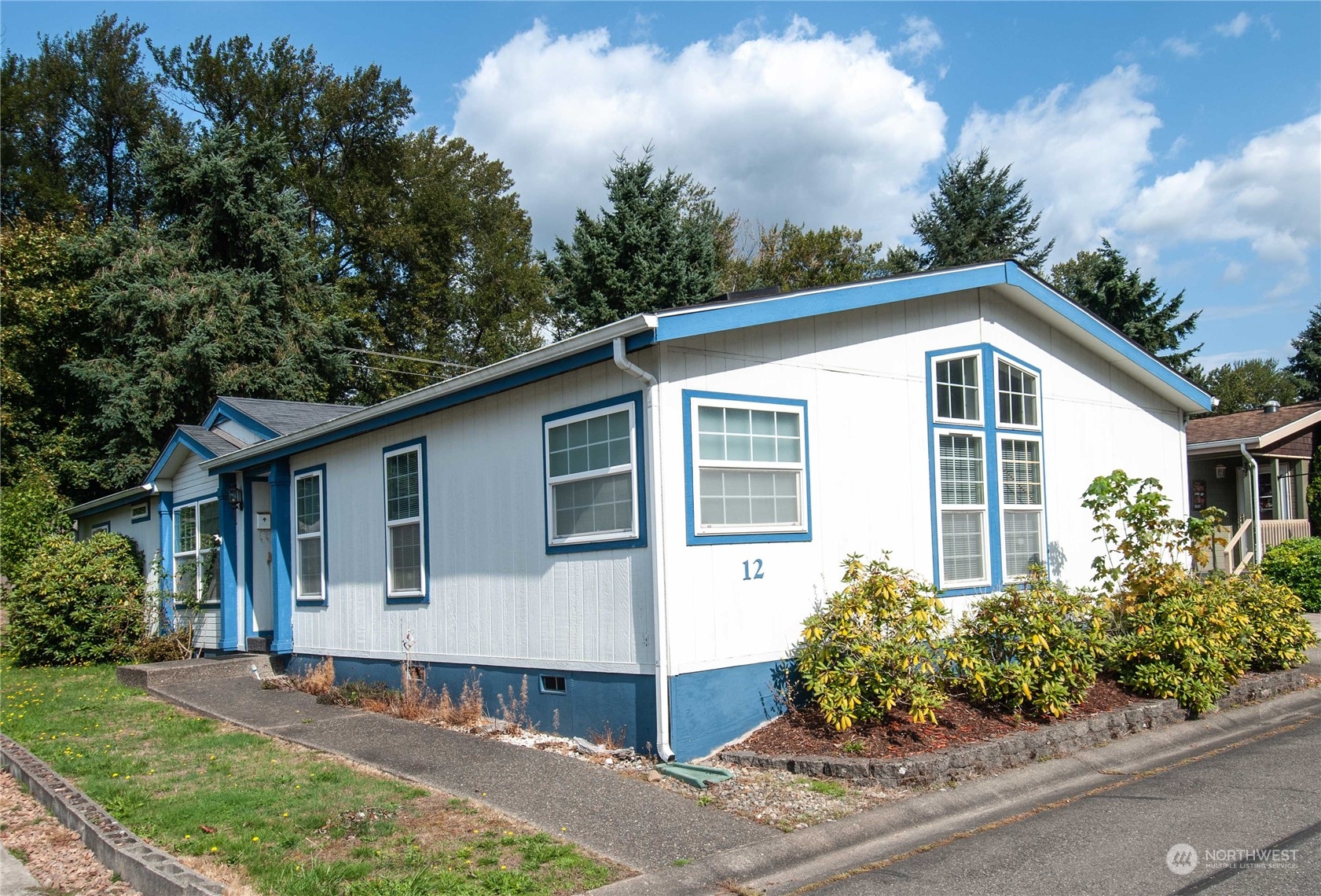 15400 Southeast 155th Place, Unit 12 Renton, WA 98058 - Photo 3 of 21 a front view of a house with a garden