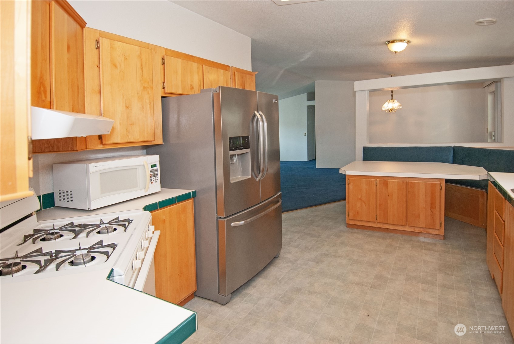 15400 Southeast 155th Place, Unit 12 Renton, WA 98058 - Photo 10 of 21 a kitchen with stainless steel appliances granite countertop a refrigerator and a stove