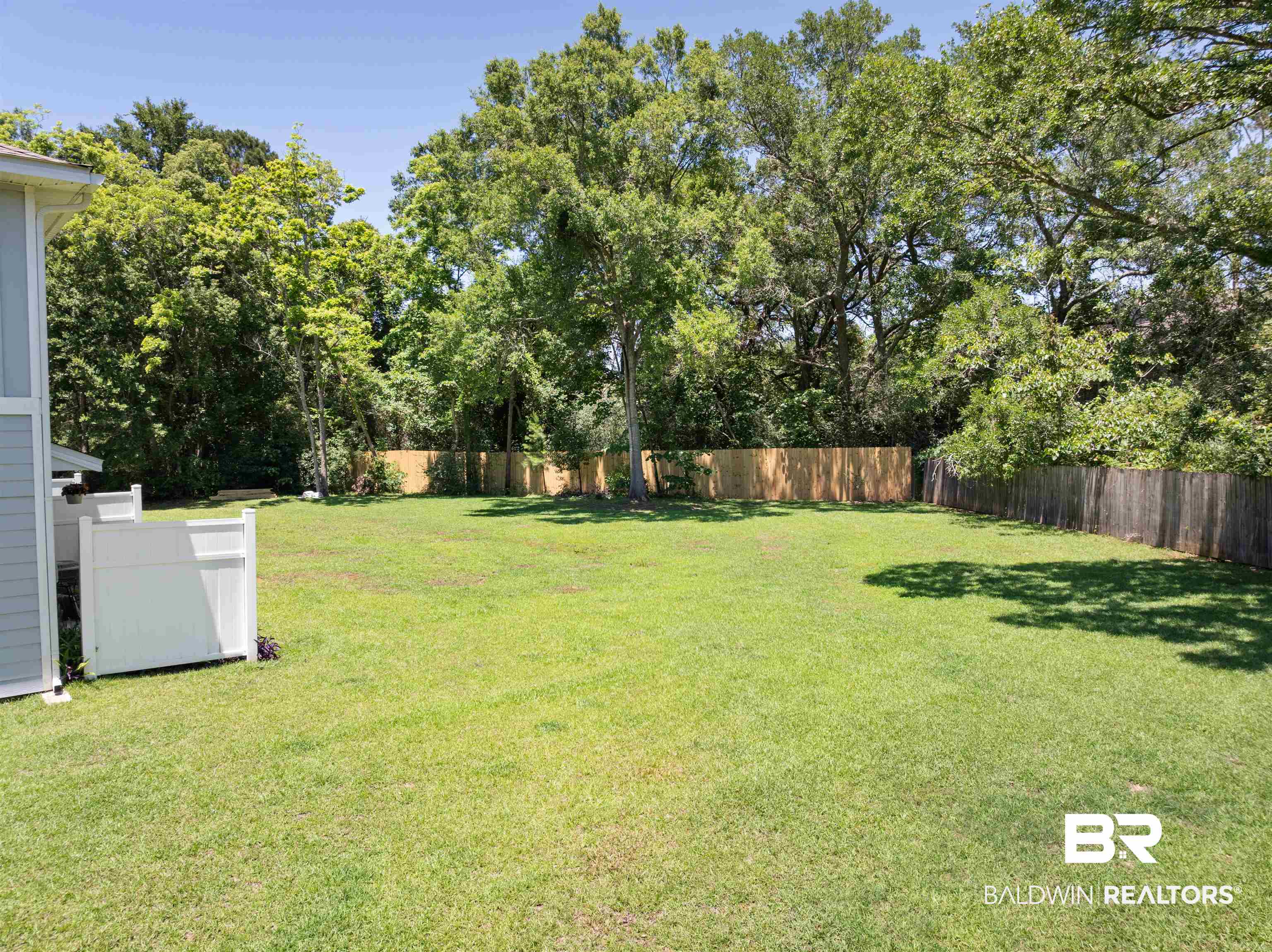 25806 Pollard Road, Unit 6 Daphne, AL 36526 - Photo 29 of 38 Expansive green lawn providing ample outdoor space
