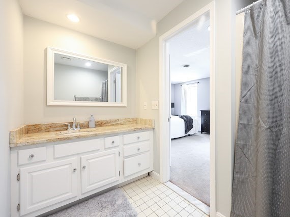 14 Shaw Farm Road, Unit 14 Canton, MA 02021 - Photo 21 of 34 a en suite bathroom with a granite countertop sink and a mirror