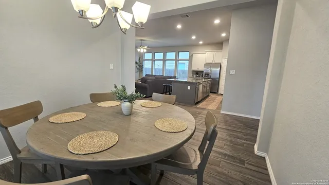 a view of a dining room with furniture and wooden floor