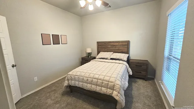 a bedroom with a bed and a window