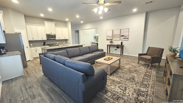 a living room with furniture and kitchen view