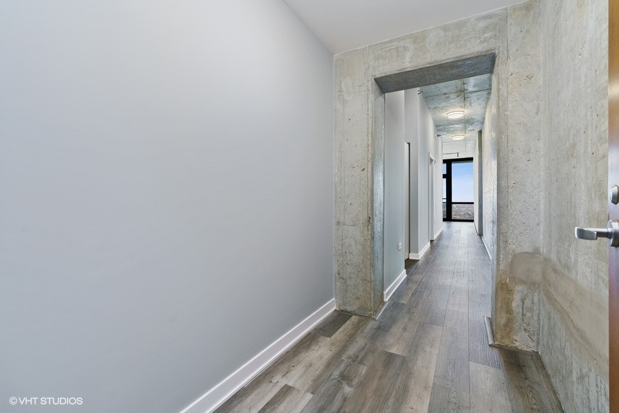 235 West Van Buren Street, Unit 4409 Chicago, IL 60607 - Photo 7 of 26 a view of a hallway with wooden floor