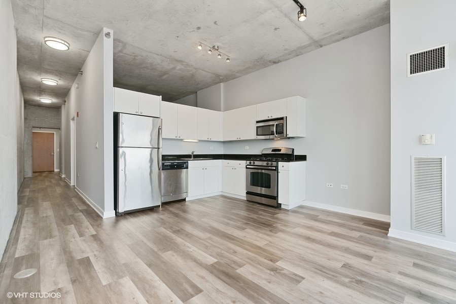 235 West Van Buren Street, Unit 4409 Chicago, IL 60607 - Photo 10 of 26 a view of kitchen with stainless steel appliances refrigerator oven and cabinets
