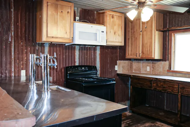 a kitchen with a stove a sink and cabinets