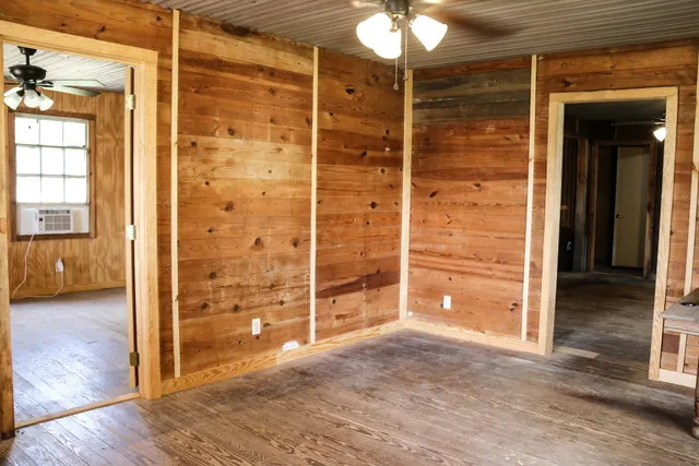 an empty room with window and a bathroom