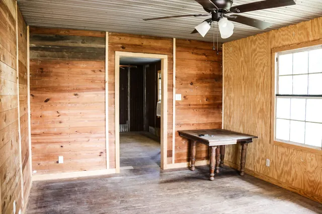 a view of entryway with a wooden door and a tub