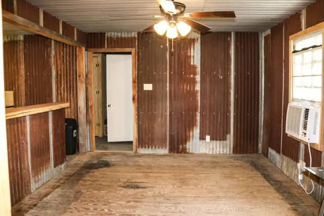a view of a house with a door and wooden walls