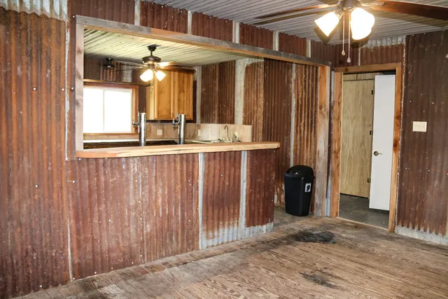 a kitchen with stainless steel appliances granite countertop a sink window and cabinets