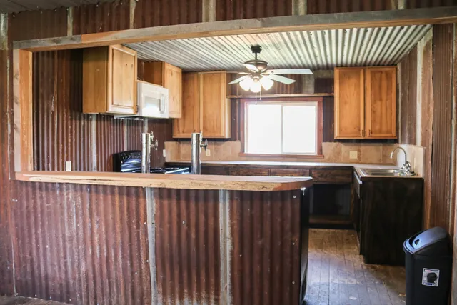 a kitchen with a sink cabinets and window