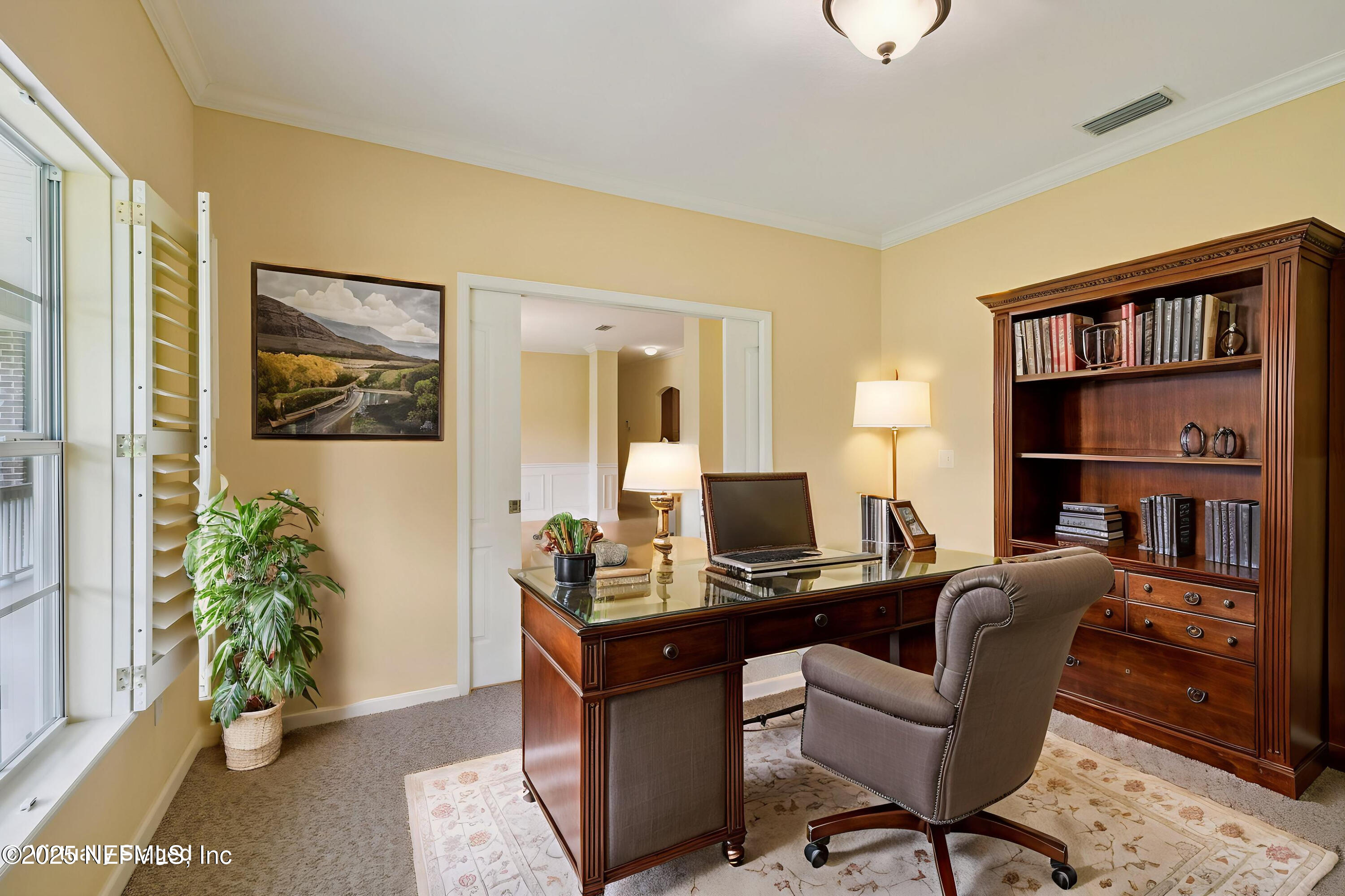 5802 Manning Cemetery Road Jacksonville, FL 32234 - Photo 12 of 117 a view of a workspace with furniture and a potted plant