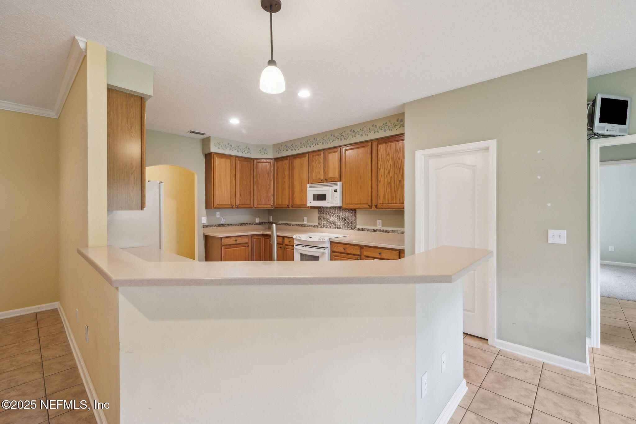 5802 Manning Cemetery Road Jacksonville, FL 32234 - Photo 22 of 117 a kitchen with stainless steel appliances granite countertop a refrigerator a oven a sink with island and chairs