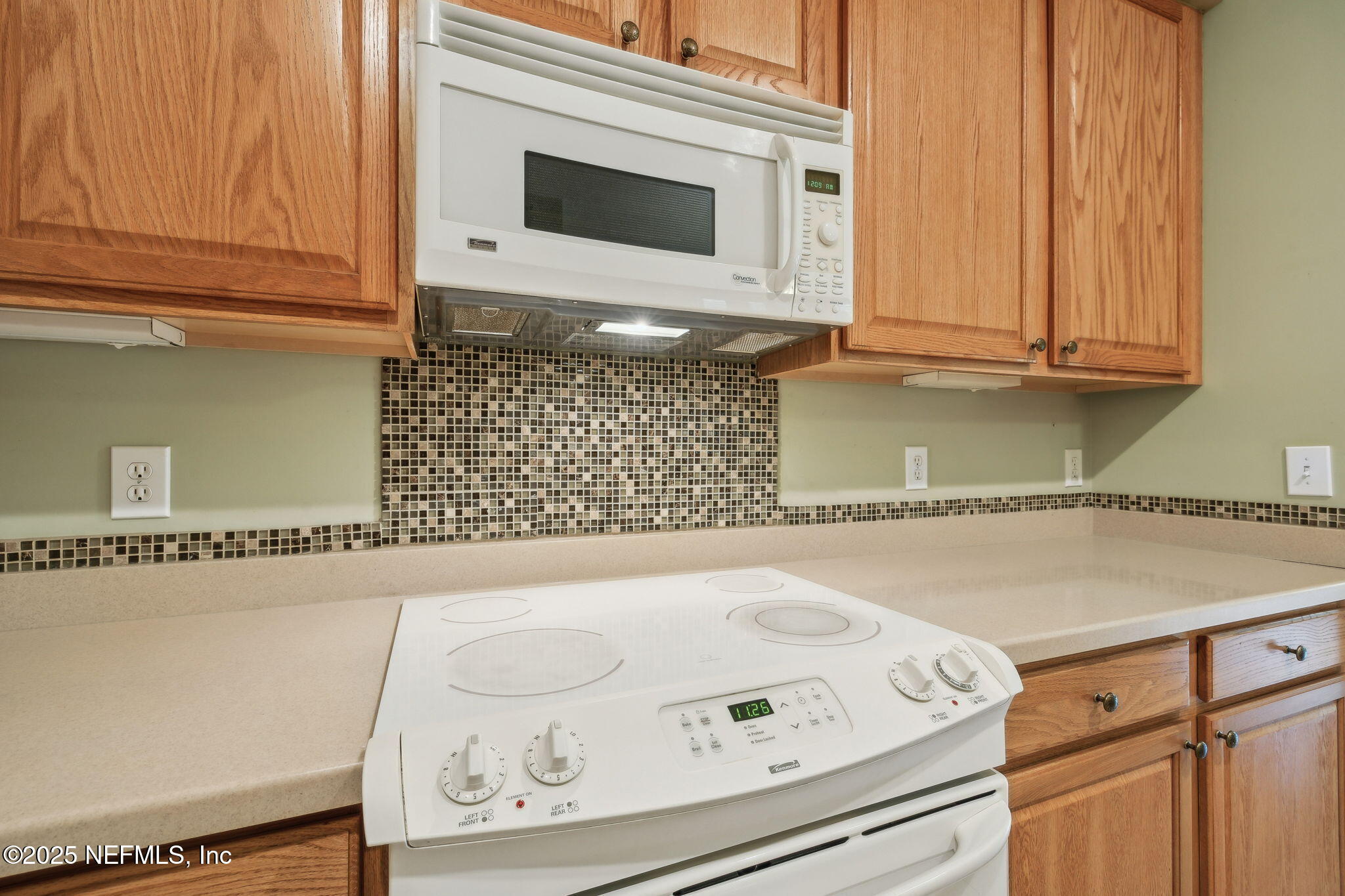 5802 Manning Cemetery Road Jacksonville, FL 32234 - Photo 26 of 117 a kitchen with a stove and a microwave