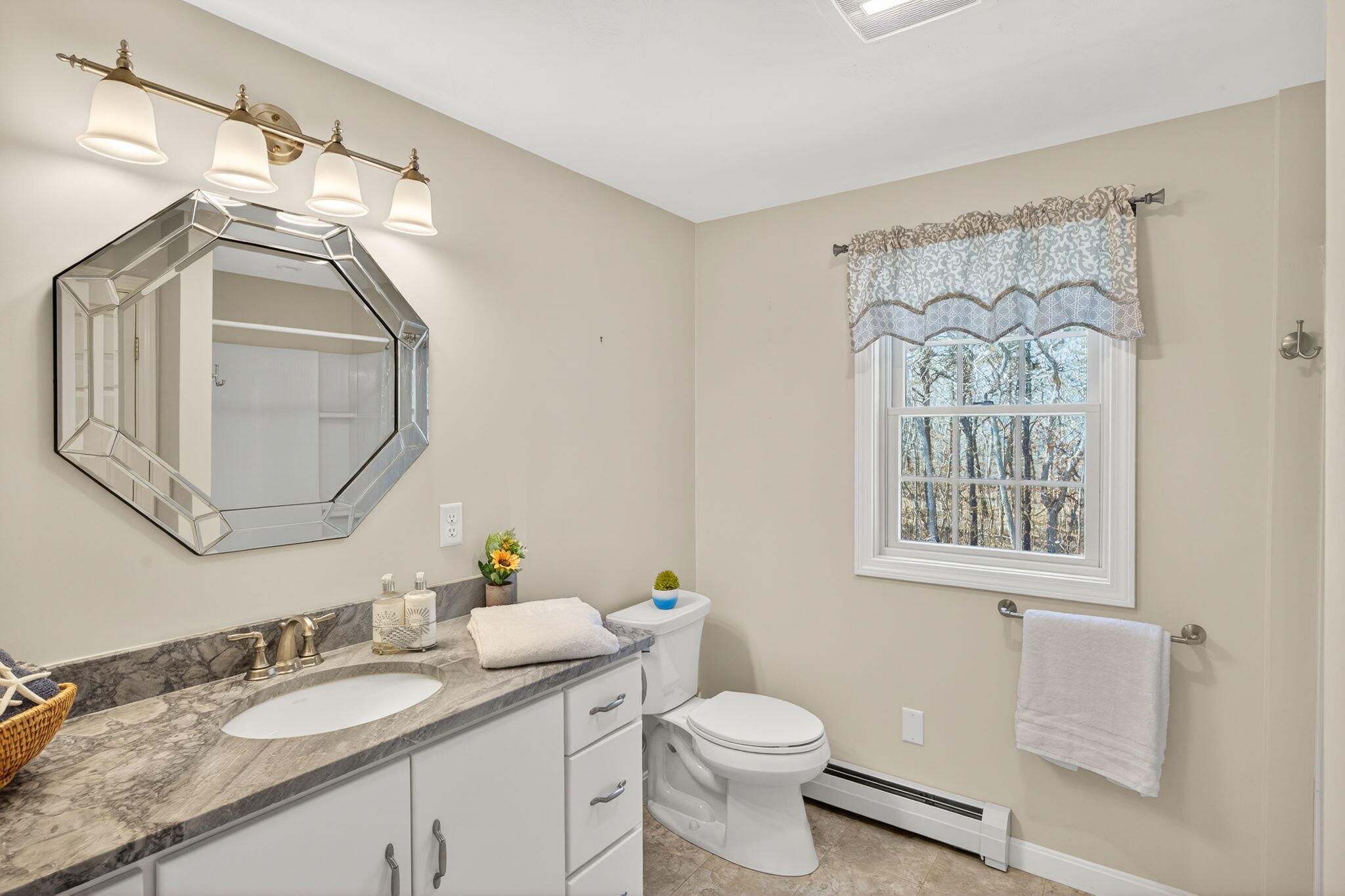 23 Dundee Circle Harwich, MA 02645 - Photo 20 of 33 a bathroom with a granite countertop sink a toilet and a mirror