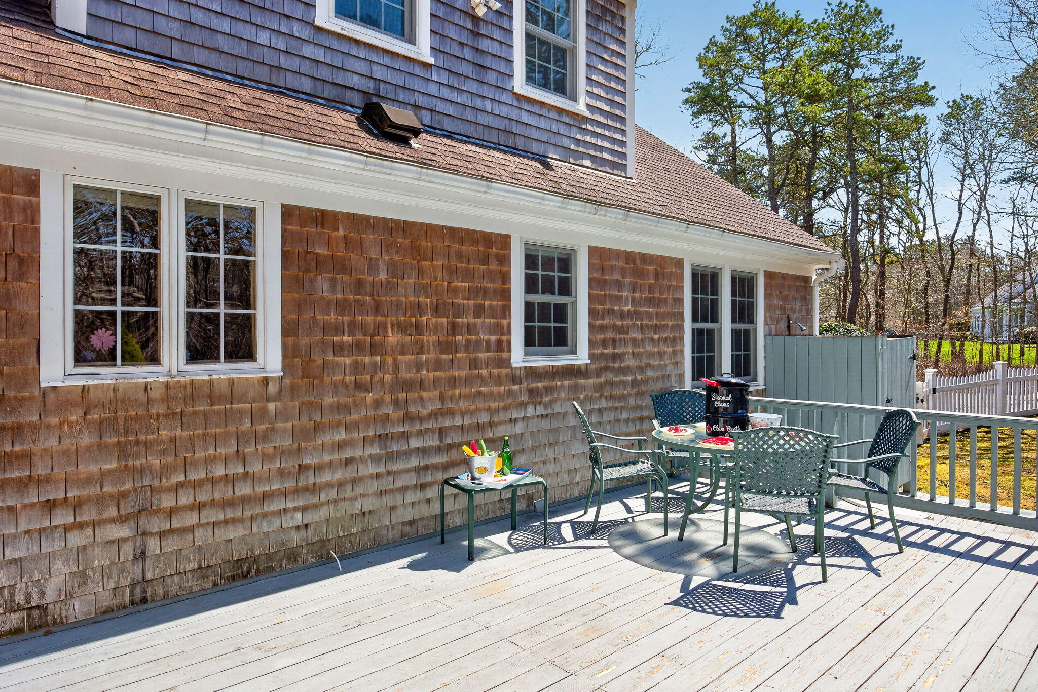 23 Dundee Circle Harwich, MA 02645 - Photo 21 of 33 a view of a deck with table and chairs and wooden floor