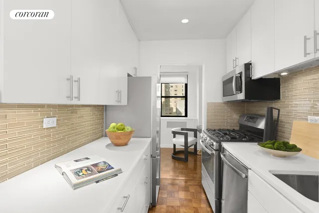 a kitchen with a sink a counter and appliances