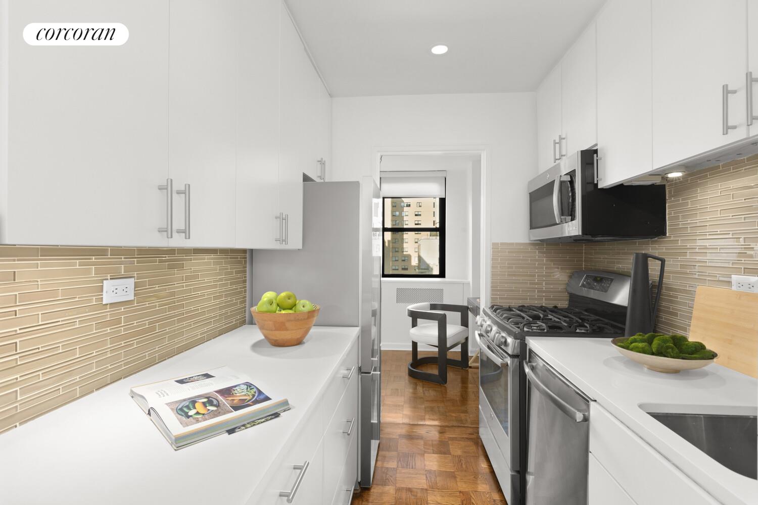 239 East 79th Street, Unit 12K Manhattan, NY 10075 - Photo 5 of 14 a kitchen with a sink a counter and appliances