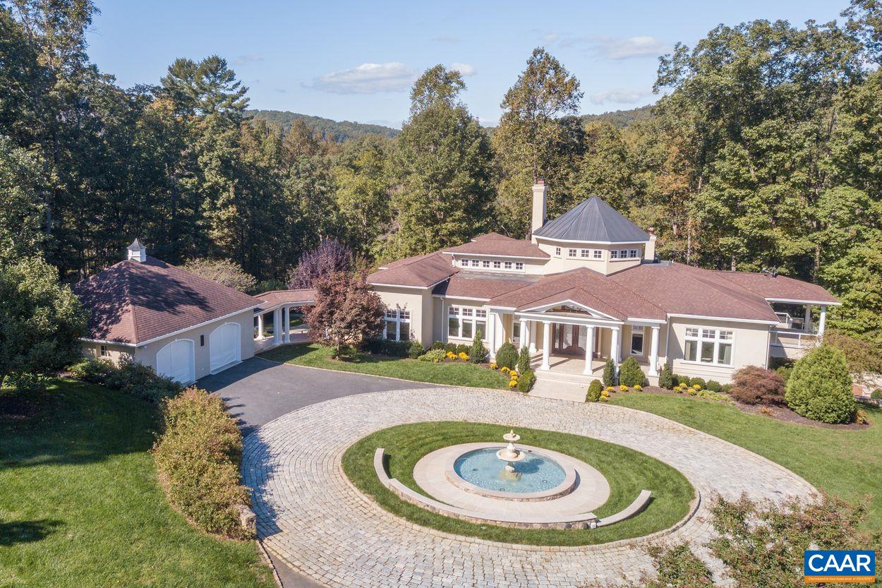 a front view of a house with a yard and trees