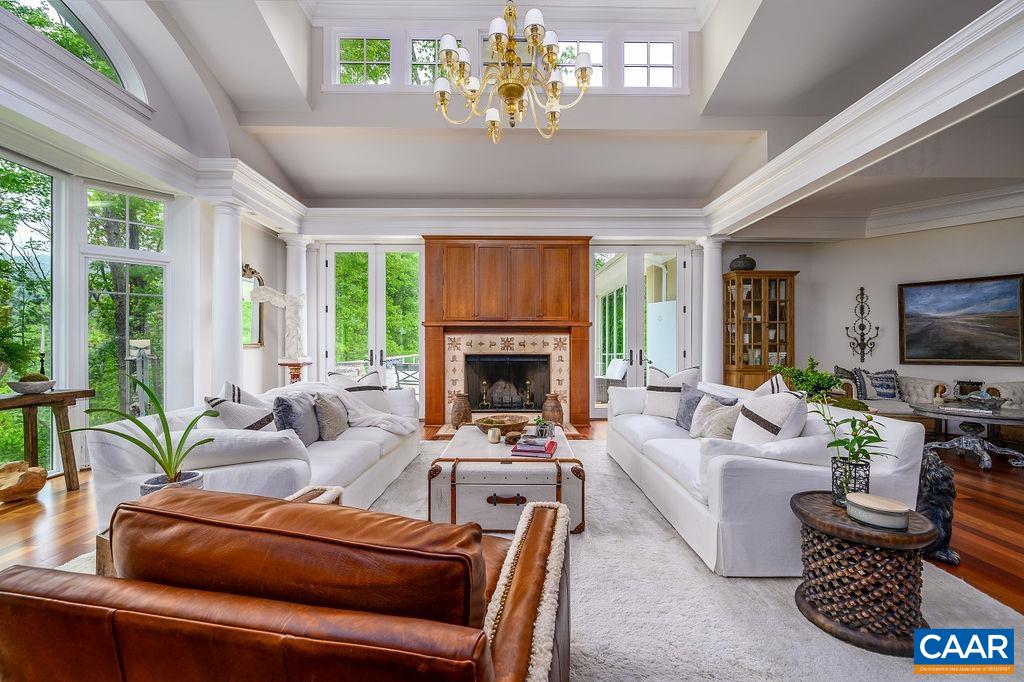 2408 Old Lynchburg Road Charlottesville, VA 22903 - Photo 13 of 71 a living room with furniture a chandelier and a fireplace