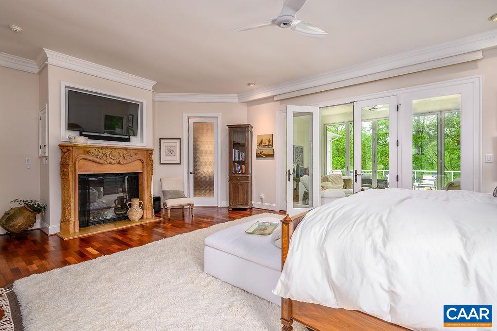 2408 Old Lynchburg Road Charlottesville, VA 22903 - Photo 28 of 71 a spacious bedroom with a bed and a fireplace