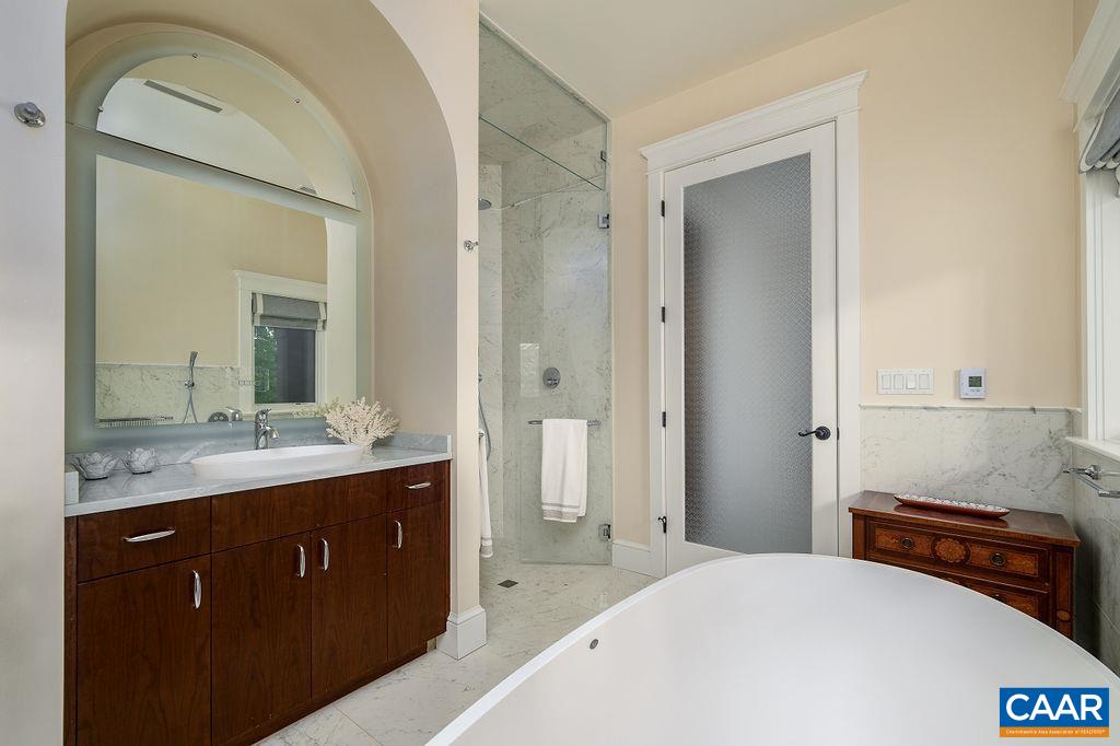 2408 Old Lynchburg Road Charlottesville, VA 22903 - Photo 46 of 71 a en suite bathroom with a granite countertop sink and a mirror