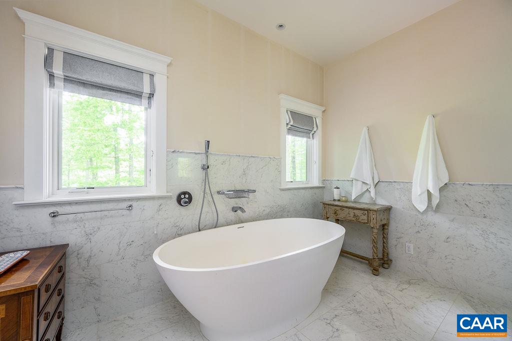 2408 Old Lynchburg Road Charlottesville, VA 22903 - Photo 47 of 71 a white bath tub sitting in a bathroom next to a window