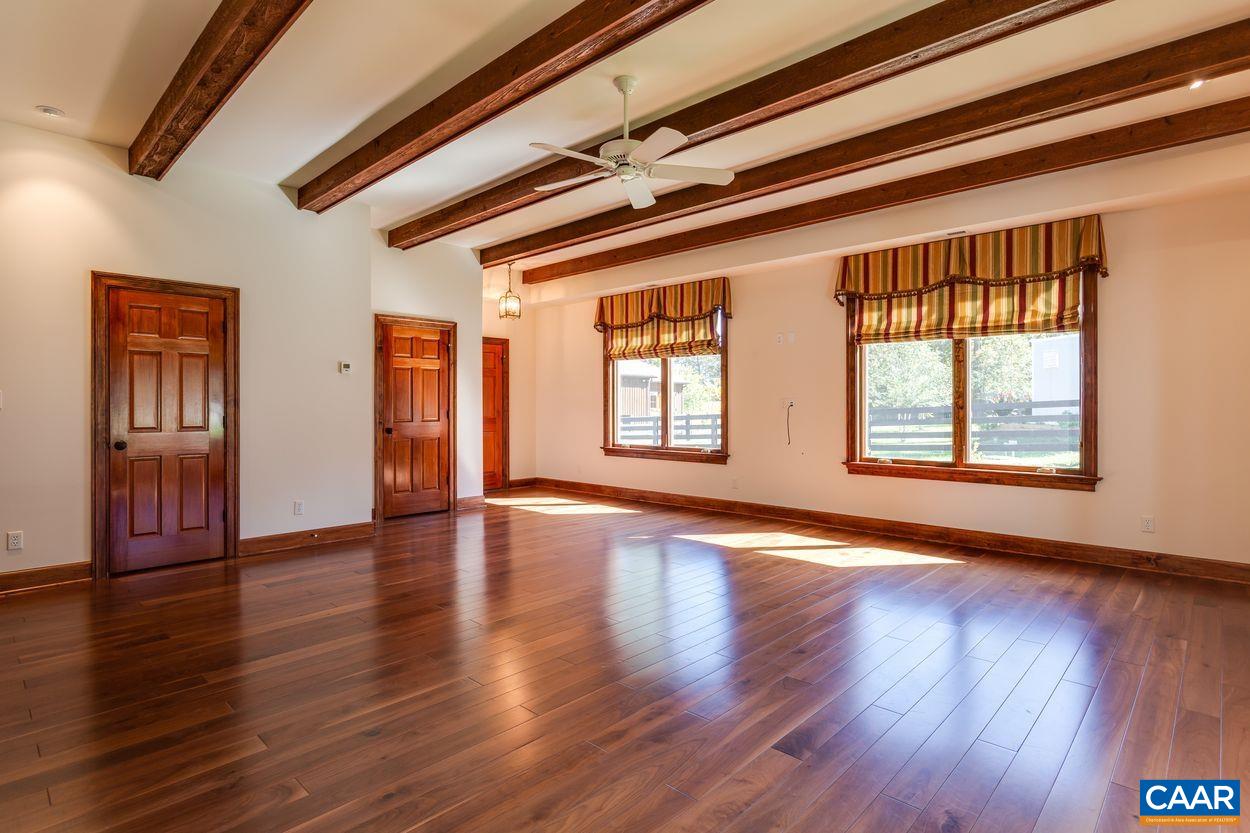 2408 Old Lynchburg Road Charlottesville, VA 22903 - Photo 62 of 71 a view of an empty room with wooden floor and windows