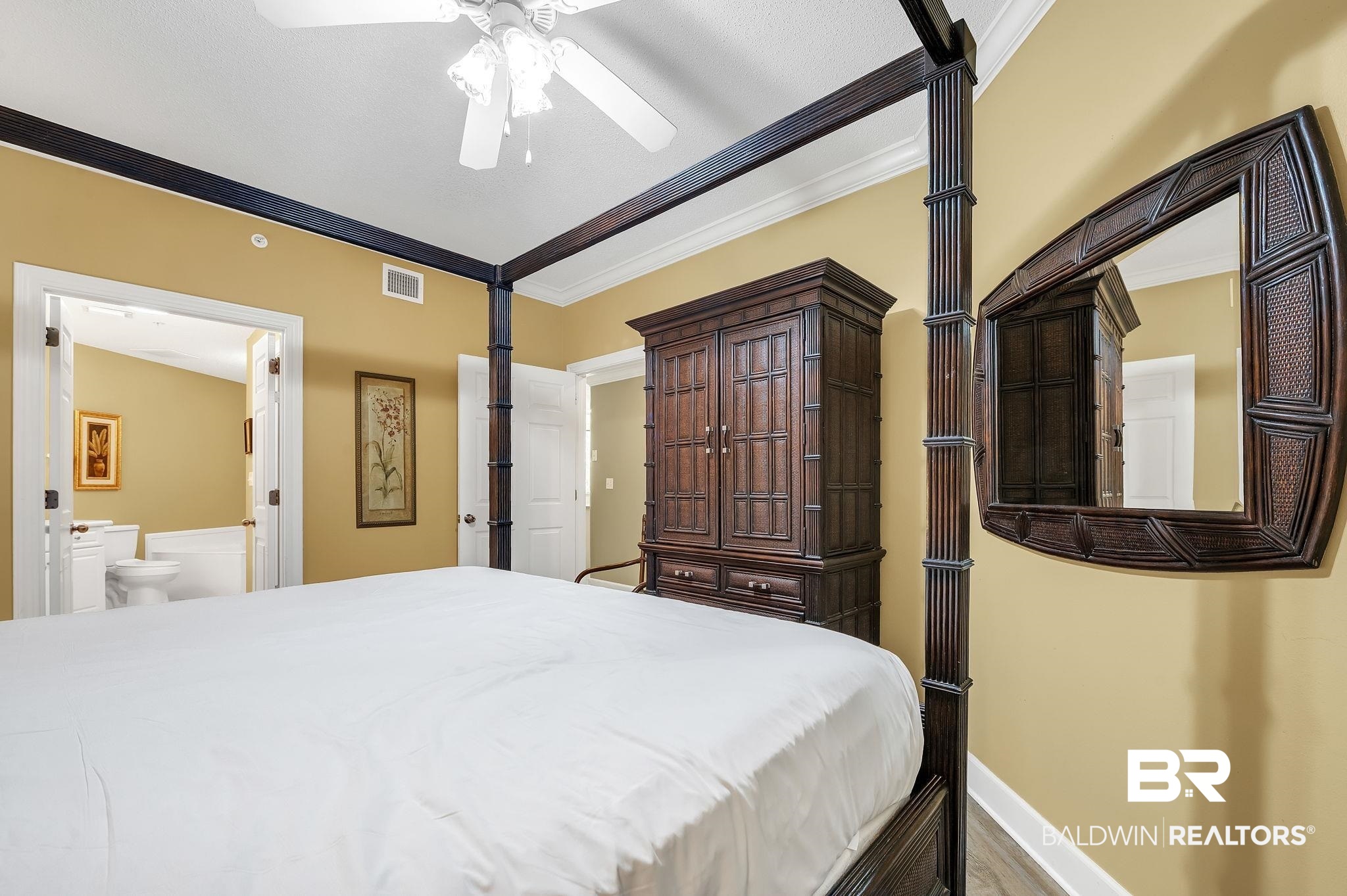 27580 Canal Road, Unit 1214 AND BOAT SLIP #62 Orange Beach, AL 36561 - Photo 28 of 67 Bedroom with ensuite bathroom, ornamental molding, visible vents, wood finished floors, and baseboards