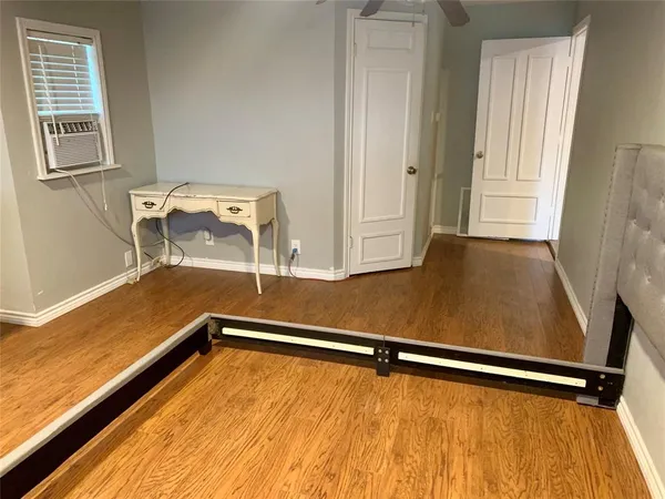 a view of a room with wooden floor and chair