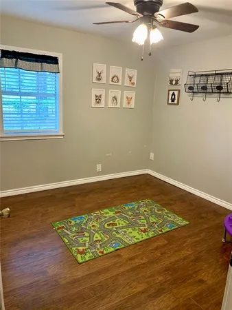 a view of a room with wooden floor and cabinet