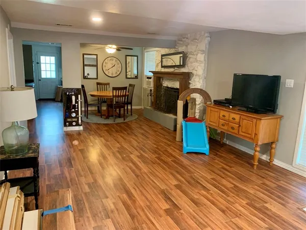 a living room with furniture and wooden floor