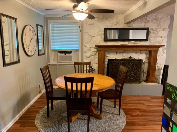 a view of a dining room with furniture and a fireplace
