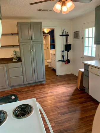 a kitchen with a refrigerator and a stove top oven