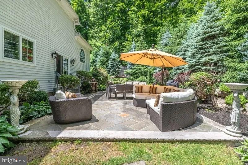 12 Upper Lake Road Oak Ridge, NJ 07438 - Photo 24 of 25 a view of a patio with couches table and chairs under an umbrella