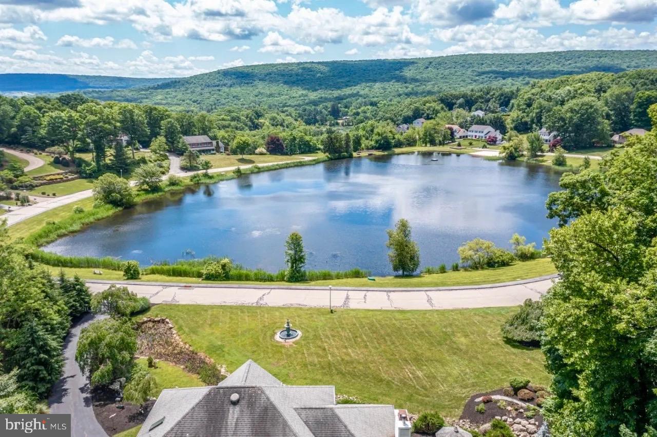 12 Upper Lake Road Oak Ridge, NJ 07438 - Photo 4 of 25 an aerial view of a house with a garden and lake view