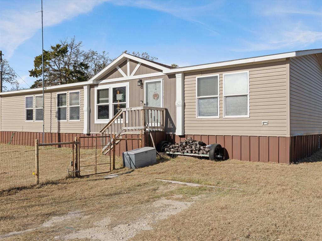 2722 Denver Road Sunset, TX 76270 - Photo 2 of 19 a view of a house with a yard and seating space