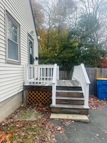 a backyard of a house with table and chairs