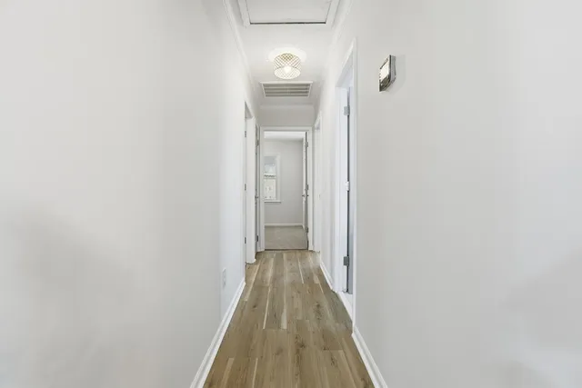 a view of a hallway with wooden floor