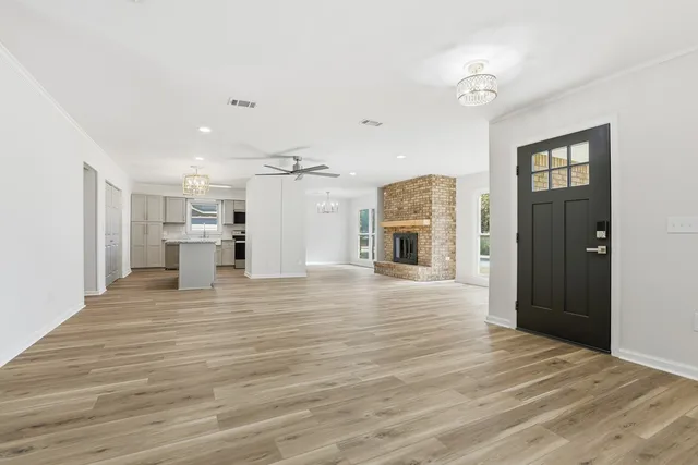 a view of a livingroom with a furniture wooden floor and a kitchen
