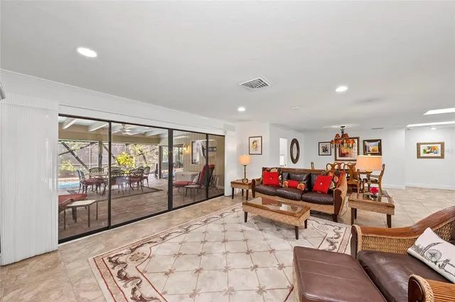 a living room with furniture and a dining table