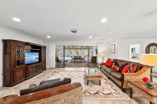 a kitchen with stainless steel appliances kitchen island granite countertop a refrigerator a stove a sink dishwasher with a dining table and chairs