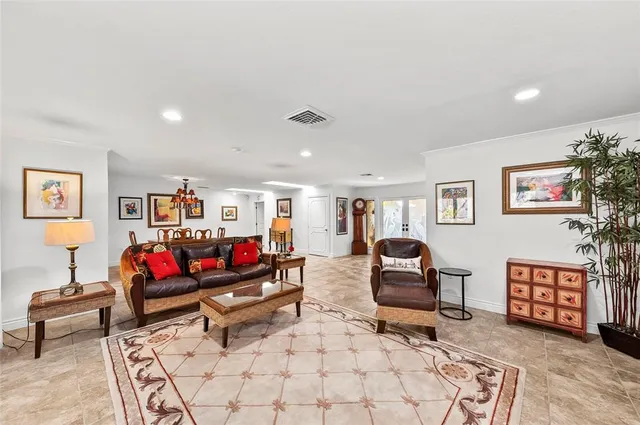 a kitchen with stainless steel appliances kitchen island granite countertop a stove sink and cabinets