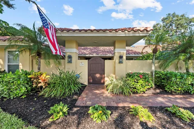 a front view of a house with a yard and a wooden fence