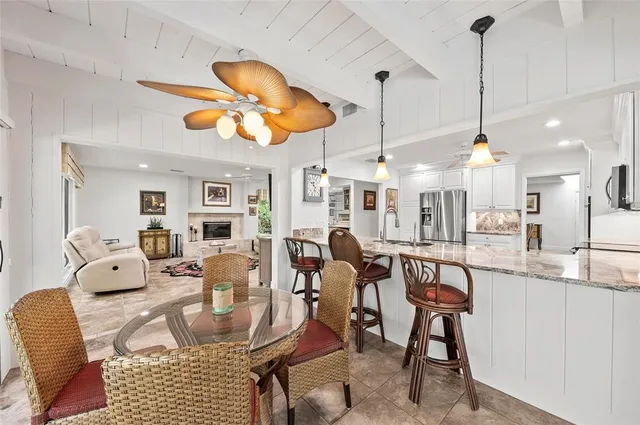 a bathroom with a toilet sink mirror vanity and vanity