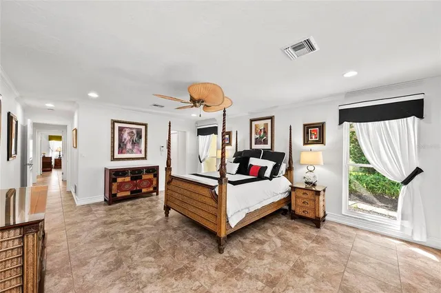a bedroom with a large bed and a chandelier