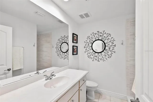 a large white kitchen with granite countertop lots of white stainless steel appliances